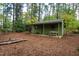 Small guest house with covered porch and picnic table at 715 Powell Dr, Raleigh, NC 27606