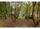 Brick house with a patio, partially visible through trees at 715 Powell Dr, Raleigh, NC 27606