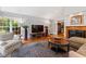 Living room features hardwood floors, a fireplace, and large windows at 715 Powell Dr, Raleigh, NC 27606