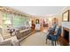 Charming living room with hardwood floors, striped sofa, and views into dining area at 715 Powell Dr, Raleigh, NC 27606