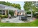 Large stone patio with seating area and pergola at 715 Powell Dr, Raleigh, NC 27606