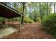 Covered patio area surrounded by trees at 715 Powell Dr, Raleigh, NC 27606