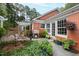 Brick patio with lush landscaping and access to the home at 715 Powell Dr, Raleigh, NC 27606