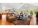 Sunroom boasts vaulted ceiling, hardwood floors, and comfortable seating at 715 Powell Dr, Raleigh, NC 27606