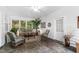 Sunroom with tiled floor, wicker furniture, and large windows at 715 Powell Dr, Raleigh, NC 27606