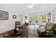 Bright sunroom with tiled floor, wicker furniture, and access to backyard at 715 Powell Dr, Raleigh, NC 27606