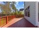 Beautiful wooden back deck of a two-story home, surrounded by mature trees at 8005 Sundance Cir, Durham, NC 27713