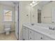 Bright bathroom featuring a double sink vanity and large mirror at 8005 Sundance Cir, Durham, NC 27713