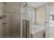 Luxurious bathroom featuring glass shower, soaking tub, and neutral tile at 8005 Sundance Cir, Durham, NC 27713