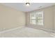Cozy bedroom with neutral walls and a large window providing natural light at 8005 Sundance Cir, Durham, NC 27713
