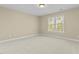Neutral bedroom with a large window offering natural light at 8005 Sundance Cir, Durham, NC 27713