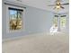 Bright bedroom with dual windows, ceiling fan, and plush carpet at 8005 Sundance Cir, Durham, NC 27713