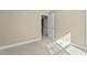 Neutral bedroom featuring wall-to-wall carpet and a door leading to the stairway at 8005 Sundance Cir, Durham, NC 27713