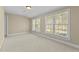 Bright bedroom with multiple windows and neutral carpet at 8005 Sundance Cir, Durham, NC 27713