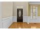 Welcoming entryway with hardwood floors, decorative moldings, and a front door with glass inlays at 8005 Sundance Cir, Durham, NC 27713