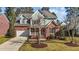 Inviting two-story home featuring a brick facade, well-kept lawn, and traditional architectural details at 8005 Sundance Cir, Durham, NC 27713
