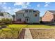 Two-story home exterior featuring a wooden deck, well-maintained lawn, a garden, and lush greenery at 8005 Sundance Cir, Durham, NC 27713