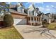 Charming two-story brick home with attached garage and well-manicured front yard and covered entryway at 8005 Sundance Cir, Durham, NC 27713