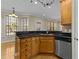Kitchen with stainless steel dishwasher, granite counters, wooden cabinets, light hardwood floors and lots of natural light at 8005 Sundance Cir, Durham, NC 27713