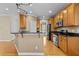 Well-equipped kitchen with wooden cabinets, granite counters, stainless steel appliances, and hardwood flooring at 8005 Sundance Cir, Durham, NC 27713