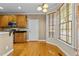 Cozy eat-in kitchen area with bright windows, light hardwood floors, wooden cabinets, and stainless appliances at 8005 Sundance Cir, Durham, NC 27713