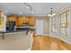 Bright kitchen features stainless appliances, wooden cabinets, granite counters, and a breakfast area with plenty of natural light at 8005 Sundance Cir, Durham, NC 27713