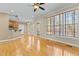 Expansive living area showcasing hardwood floors, large windows, and seamless transition to the kitchen and dining space at 8005 Sundance Cir, Durham, NC 27713