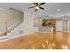 Open-concept living space featuring hardwood floors, staircase, and view to the kitchen, perfect for Gathering gatherings at 8005 Sundance Cir, Durham, NC 27713