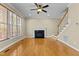 Bright living room featuring hardwood floors, cozy fireplace, staircase and great natural light at 8005 Sundance Cir, Durham, NC 27713