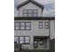 Rear view of townhome with private patio and covered exterior access at 962 Double Helix Rd, Apex, NC 27523
