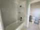 Bathroom with a tub and shower combo featuring white subway tile and black fixtures at 1031 Coldspring Circle, Durham, NC 27705