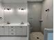 Bathroom featuring double sink vanity with matte black fixtures and a walk-in shower at 1031 Coldspring Circle, Durham, NC 27705