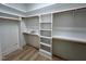 Walk-in closet with custom white shelving and wood rods for maximum storage at 1031 Coldspring Circle, Durham, NC 27705