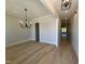 Open floor plan combining the Dining Room and Hallway with hardwood floors at 1031 Coldspring Circle, Durham, NC 27705