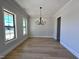 Light filled dining room with modern chandelier and hardwood floors at 1031 Coldspring Circle, Durham, NC 27705