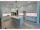 Spacious kitchen with white cabinetry, stainless steel appliances, and a central island at 1031 Coldspring Circle, Durham, NC 27705