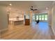 Open floor plan combining kitchen, living, and sunroom with hardwood floors at 1031 Coldspring Circle, Durham, NC 27705