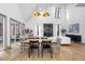 Bright dining room with hardwood floors, a modern light fixture, and access to a deck at 113 Laurston Ct, Durham, NC 27712