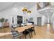 Bright dining room with hardwood floors, a modern light fixture, and access to a deck at 113 Laurston Ct, Durham, NC 27712