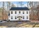 Two-story white farmhouse with black windows, and a welcoming front porch at 113 Laurston Ct, Durham, NC 27712