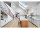 Modern kitchen with white cabinets, island, and skylights at 113 Laurston Ct, Durham, NC 27712
