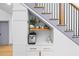 Built-in coffee bar under the stairs, featuring white cabinets and a quartz countertop at 113 Laurston Ct, Durham, NC 27712