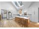 Modern kitchen with white cabinets, large island, and skylights at 113 Laurston Ct, Durham, NC 27712
