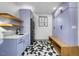 Laundry room with purple cabinets, geometric floors and built-in bench at 113 Laurston Ct, Durham, NC 27712