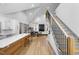 Open concept living room with hardwood floors, a modern fireplace, and large windows at 113 Laurston Ct, Durham, NC 27712