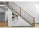 Modern staircase with black metal balusters and a built-in storage unit underneath at 113 Laurston Ct, Durham, NC 27712