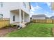 Backyard with deck, white siding home, and wooden fence, perfect for outdoor entertaining at 129 Mossy Falls Way, Wendell, NC 27591