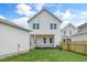 Expansive backyard with green lawn, white siding home, and wooden fence, perfect for outdoor activities at 129 Mossy Falls Way, Wendell, NC 27591