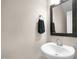 Cozy half bathroom featuring a white vessel sink with a dark framed mirror at 129 Mossy Falls Way, Wendell, NC 27591