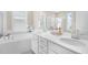 A bathroom with dual sinks and a separate tub and shower at 129 Mossy Falls Way, Wendell, NC 27591